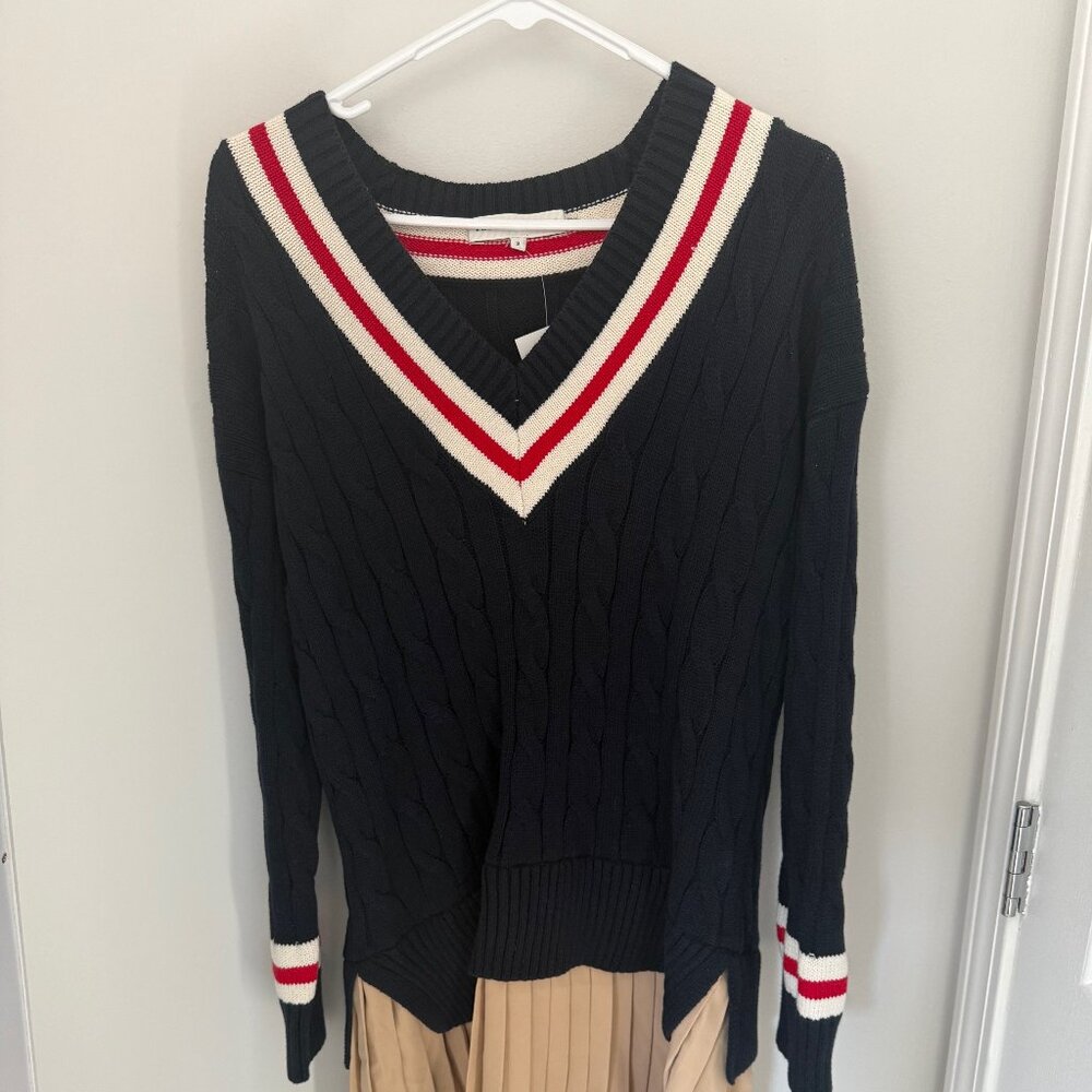 Sweater dress with a ruffled beige skirt.